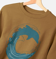 Close-up of dolphin design on brown crewneck sweatshirt