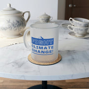 Mug on table with 'Fight Climate Change' slogan.