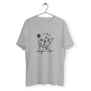 a white t - shirt with a drawing of a surfer on it